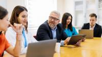 An administrative director meeting with doctors and administrative residents and fellows